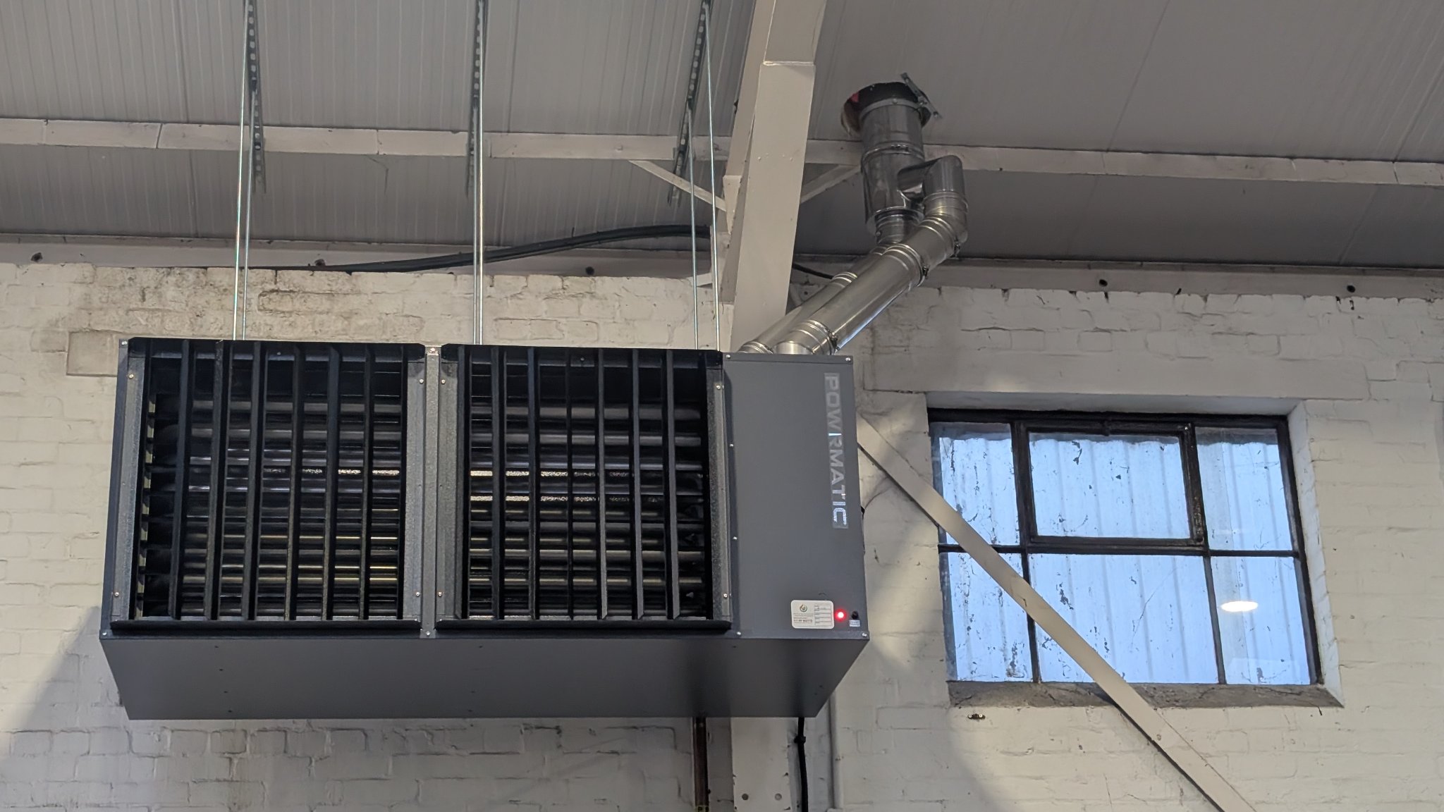 New Powrmatic gas fired unit heater installed at high level in a warehouse in Reading